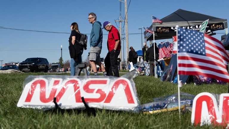 La gente llega al Museo del Aire y el Espacio Neil Armstrong para ver el eclipse solar total en Wapakoneta, Ohio