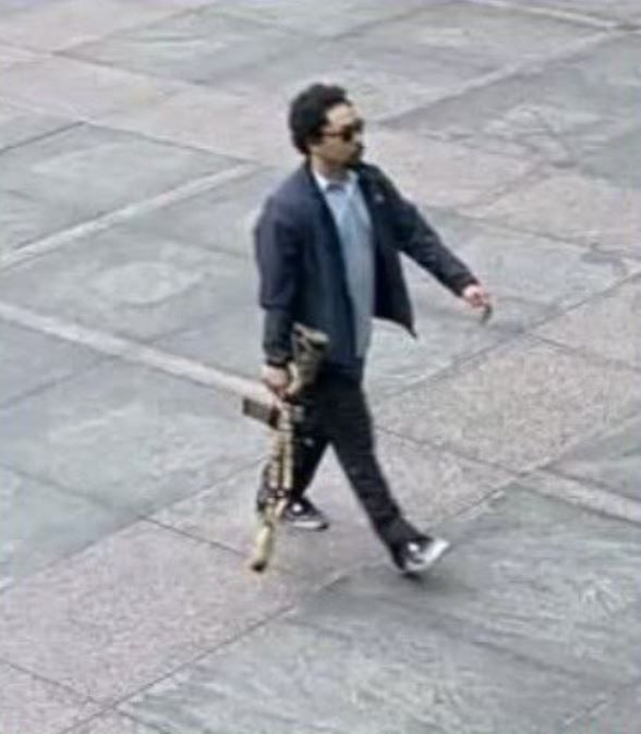 El tirador, Shane Devon Tamura, capturado por cámara de seguridad ingresando al edificio